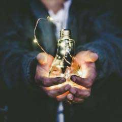 Image of a person holding a light bulb