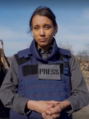 Isabella reporting from Ukraine in blue and grey Press uniform