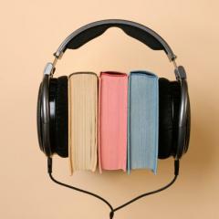 Three books with headphones holding them together.