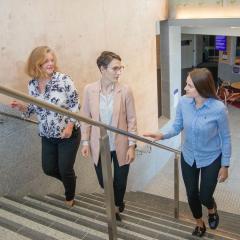 Dr Sabine Matook, Dr Angie Knaggs and Lara Harbers walking up the stairs together.
