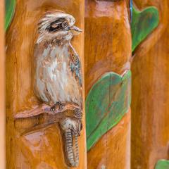 Wooden marker poles painted with plants and birds at UQ St Lucia