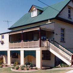 A 'Queenslander' style house on stilts with a veranda. 