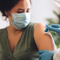 A woman receiving a COVID-19 vaccination