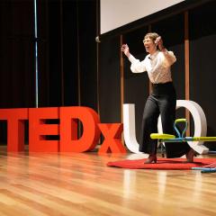 An image of a TEDxUQ presenter on stage