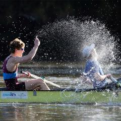 Student rowers splash the water after finishing sprint races on the Brisbane River during the Trans-Tasman Varsity Challenge.