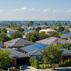 Aerial view of residential houses in an Australian suburb. Elevated view of Australian homes against blue sky.