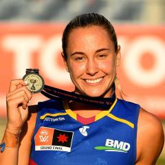UQ student and Brisbane Lions star Natalie Grider with her premiership medal after the 2023 AFLW Grand Final.