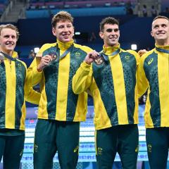 Elijah Winnington, Maximillian Giuliani, UQ student Thomas Neill (second from right) and Flynn Southam with their bronze medals after the men's 4x200 metres freestyle relay final.