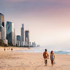 An image of a couple walking together on the beach at the Gold Coast