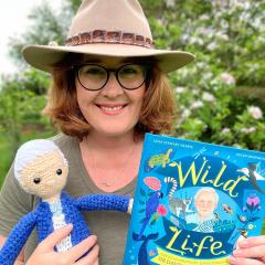 An image of UQ graduate and children's book author Leisa Stewart-Sharpe with her book 'Wild Life: The Extraordinary Adventures of Sir David Attenborough'.