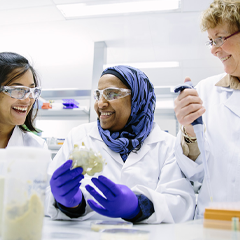 three women in lab coats