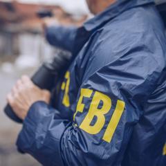 An image of an federal agent wearing an FBI jacket