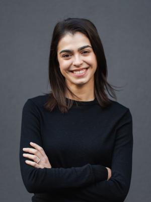 Georgia wearing a black long sleeve top and smiling to the camera