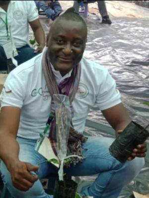 Man crouching down and smiling up at the camera
