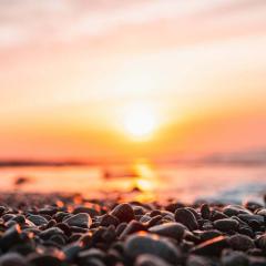 Sunrise over a pebbled beach