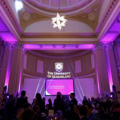 Image of people in a room lit purple