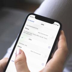 Hand holding mobile phone with VPN setting on the screen close-up view photo