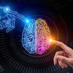 A human hand and a robot arm touching a digital graphic of a brain