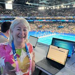UQ alum Louise Evans from her position in the poolside Media Tribune.