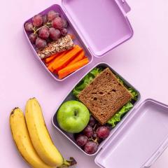 Healthy lunch boxes filled with fruits and vegetables, top view