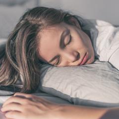 Woman sleeping on the side of her face.