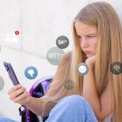 Sad girl viewing negative reactions and comments on social media, concept of children online bullying.