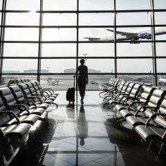 An image of a woman waiting at an airport.
