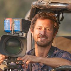 An image of Dr Chadden Hunter sitting in a jeep with a video camera attached to it.