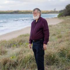 An image of sea turtle conservationist and UQ Adjunct Associate Professor Col Limpus AO PSM on the beach at Mon Repos.