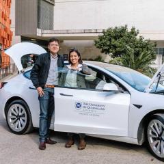 An Dr Kai Li Lim and Dr Dia Adhikari Smith with a Tesla.