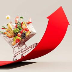 An illustration of a trolley full of groceries with an upwards arrow representing rising prices.