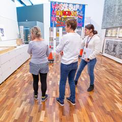 Guests at the UQ Art Museum admire works by Indigenous artists.