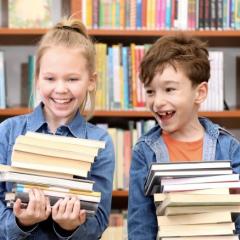Kids holding books.