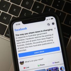 An image of a phone scree showing the Facebook app, which displays a notice explaining that the company was banning news links