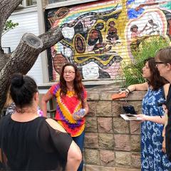 Ms Go-Sam and Dr Greenop (far right) conducting walking interviews with staff from the Aboriginal and Torres Strait Islander Studies Unit, Valeska Wood, Emma Olssen and Nell Angus. They are standing in front of artists Michelle Barney, June Breen and Joe Hurst’s 1988 White Australia has a black history mural in the Student Union Complex at St Lucia.