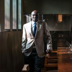 Dr Mark Deng poses in the UQ Law Library.