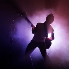 An image of a guitarist playing on stage